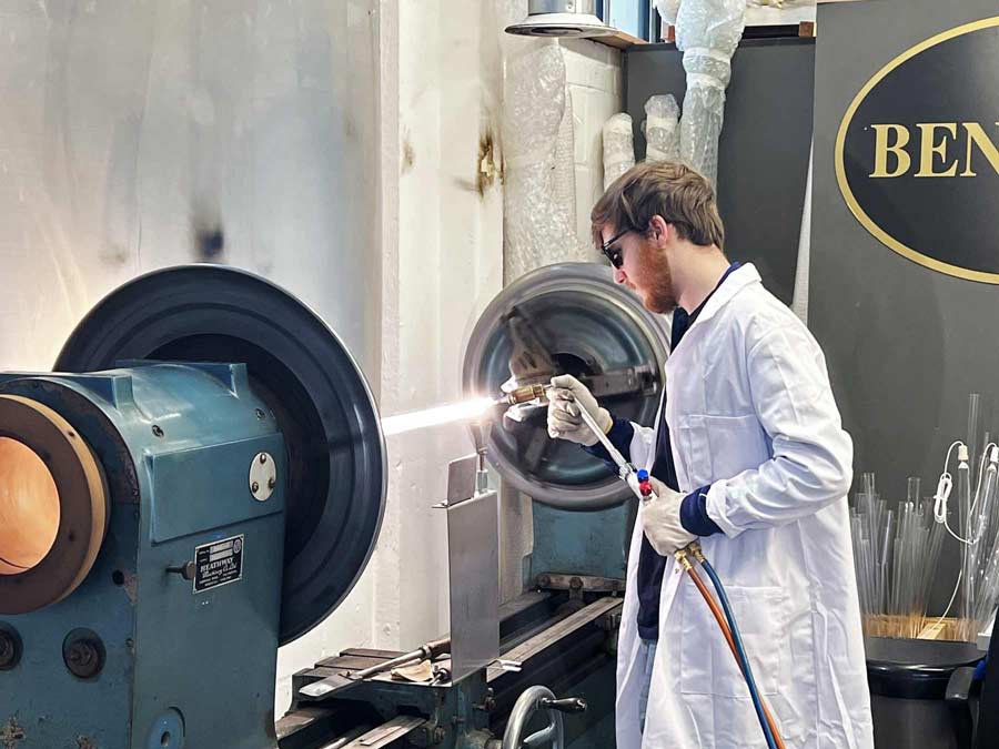 A high-temperature torch being used during the manufacturing process of a new UV curing lamp at Benford Lamps. This process creates a hermetic seal between the quartz body and the electrode assembly, ensuring the vacuum integrity the lamp.
